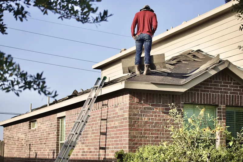 Professional roofer working on a residential roof in Orchard Hill